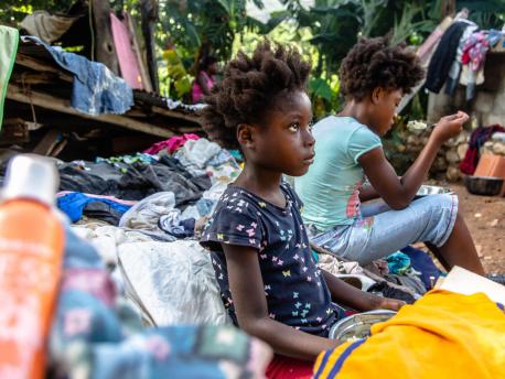 On August 18, 2021, 7-year-old Farah eats a meal at a temporary shelter in Marceline, Haiti. Farah spent two hours with his family under the rubble of their house after a 7.2 magnitude earthquake hit Haiti on August 14, 2021.
