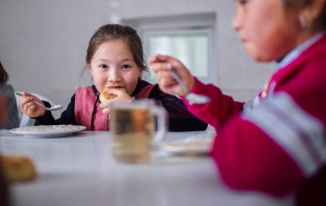 Nurel, 7, a primary school student, eats a healthy lunch prepared by a cook at Shabdan Baatyr school near Shabdan village, Chon Kemin valley, Kyrgyzstan.