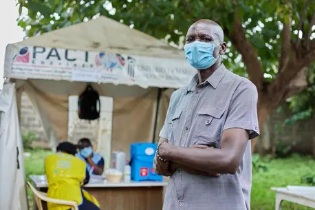 Man with Arms Folded Wearing COVID Mask