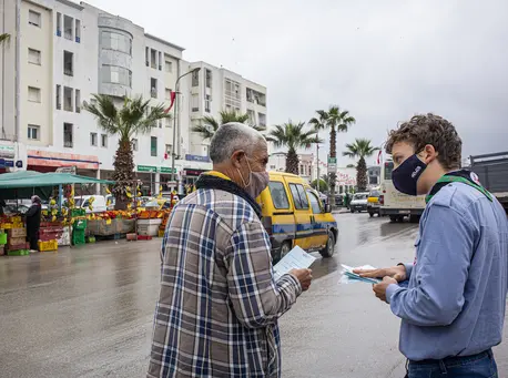 In Mhamdia, in the suburbs of Tunis, Tunisia, a group of UNICEF-trained Scouts talk to pedestrians about the risks of COVID-19 and share information about how to prevent infection. In Mhamdia, in the suburbs of Tunis, Tunisia, a group of UNICEF-trained Scouts talk to pedestrians about the risks of COVID-19 and share information about how to prevent infection.