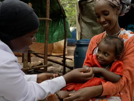 Sedalia Abdulahi, left, a health extension worker at the Bambassi IDP camp in the Benishangul-Gumuz region of western Ethiopia, visits with 2-year-old Asanti and her mother. Sedalia Abdulahi, left, is a health extension worker at the Bambassi IDP camp in the Benishangul-Gumuz region of western Ethiopia.