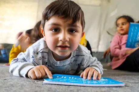 Child Reading a UNICEF Book