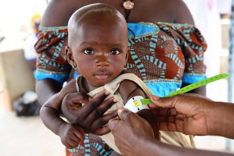 A mother with her baby at a UNICEF-supported health center in Fada, in eastern Burkina Faso where children are screened for malnutrition and vaccinated.
