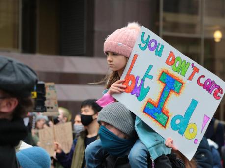 A young girl holds a sign at a Fridays for Future demonstration for climate action in Glasgow, Scotland on Nov. 5, 2021.