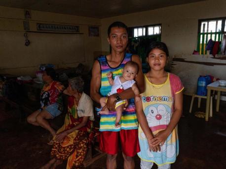 Nicole Angela Cariño, 17, her husband, Mike De Jesus, and their 3-month-old baby, Alia, set up housekeeping in a school classroom with several other families after Typhoon Rai hit Dinagat Island, the Philippines on December 16, 2021.