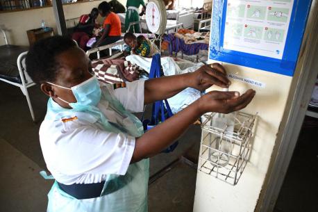 The in-charge nurse at Fort Portal Regional Referral Hospital in Uganda sanitizes her hands after attending to patients in the pediatric ward. 