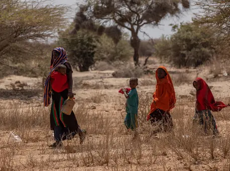 A woman and her children cross a dry field near Saglo village, Somali region, Ethiopia on January 20, 2022. A woman and her children cross a dry field near Saglo village, Somali region, Ethiopia on January 20, 2022.