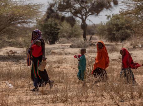 A woman and her children cross a dry field near Saglo village, Somali region, Ethiopia on January 20, 2022.