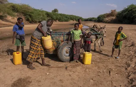 In Somalia, Ibrahim, second from left, collects what little water he can from a dried up riverbed with help from his young sons and a nephew. In Somalia, Ibrahim, second from left, collects what little water he can from a dried up riverbed with help from his young sons and a nephew.