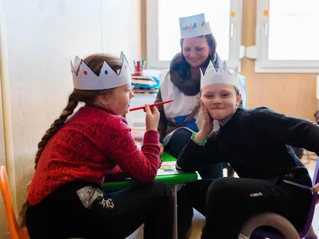 On March 19, 2022, Ivan, right, and his sister, Sofia, from Mariupol, Ukraine, play with a Blue Dot psychologist in a child-friendly space, located in the Blue Dot hub at the Palanca border crossing in the Republic of Moldova. On March 19, 2022, Ivan, right, and his sister, Sofia, from Mariupol, Ukraine, play with a Blue Dot psychologist in a child-friendly space, located in the Blue Dot hub at the Palanca border crossing in the Republic of Moldova.