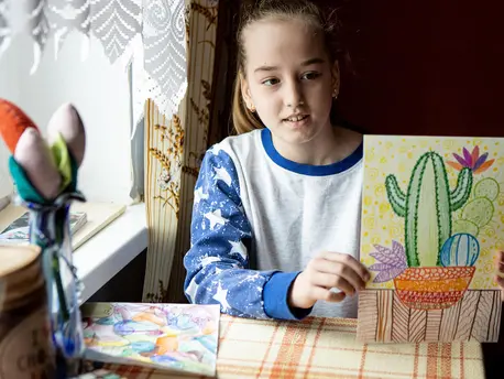 Child Holding Up Drawing