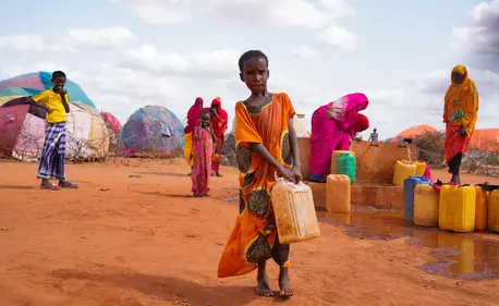 Ten-year-old Hibo carries water in a jerrycan to her temporary home at the UNICEF-supported Kaharey IDP camp in Dollow, Somalia. Ten-year-old Hibo carries water in a jerrycan to her temporary home at the UNICEF-supported Kaharey IDP camp in Dollow, Somalia.