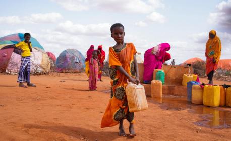 Ten-year-old Hibo carries water in a jerrycan to her temporary home at the UNICEF-supported Kaharey IDP camp in Dollow, Somalia.