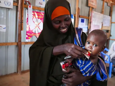 On May 24, 2022, 10-month-old Ubah is fed Ready-to-Use Therapeutic Food by her mother at UNICEF-supported Dollow Health Center in Somalia. On May 24, 2022, 10-month-old Ubah is fed Ready-to-Use Therapeutic Food by her mother at UNICEF-supported Dollow Health Center in Somalia.