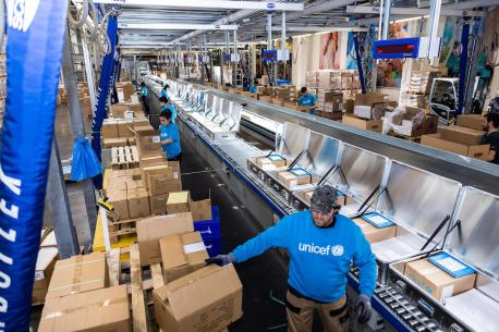 The packing line inside UNICEF's supply warehouse in Copenhagen where School-in-a-Box kits are being assembled to be dispatched to Ukraine for children displaced by war.