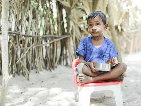 On July 5, 2022, 5-year-old Thulakshan eats his meal while sitting outside his house in the village of Devapuram, Batticaloa, Sri Lanka. On July 5, 2022, 5-year-old Thulakshan eats his meal while sitting outside his house in the village of Devapuram, Batticaloa, Sri Lanka.