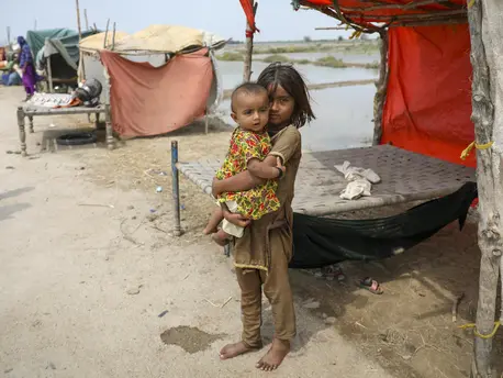 On Sept.2, 2022, six-year-old Vaidya holds her baby sister Nera beside the temporary shelter where she and her family are living in Mirpur Khas District, Sindh Province, Pakistan. On Sept.2, 2022, six-year-old Vaidya holds her baby sister Nera beside the temporary shelter where she and her family are living in Mirpur Khas District, Sindh Province, Pakistan.
