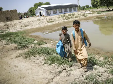 Brothers return home after attending school at a UNICEF-supported Temporary Learning Center in flood-damaged Balochistan Province, Pakistan on Sept. 7, 2022. Brothers return home after attending school at a UNICEF-supported Temporary Learning Center in flood-damaged Balochistan Province, Pakistan.