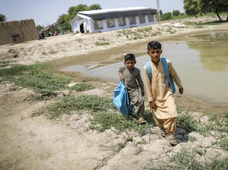 Brothers return home after attending school at a UNICEF-supported Temporary Learning Center in flood-damaged Balochistan Province, Pakistan.