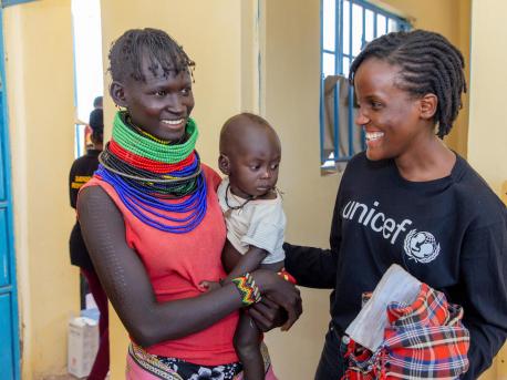 On Sept. 8, 2022, UNICEF's newest Goodwill Ambassador, Vanessa Nakate, right, with Asinyoni Ekiru, mother to 14-month-old Papos Alos at the UNICEF-supported Kobuin Health Center in Turkana County, Kenya. 