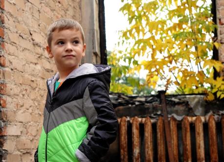 Six-year-old Denys walks through what was once his home in Shybene, Kyiv Oblast, Ukraine