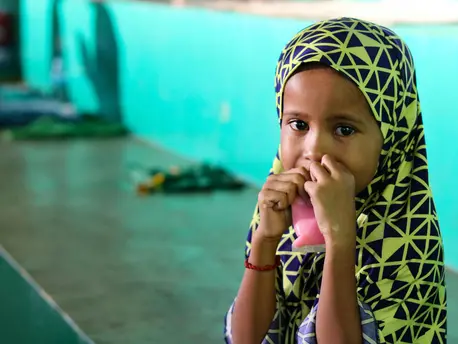 Bainor, 6, eats a snack inside a gymnasium serving as an evacuation center for children and families displaced by Severe Tropical Storm Nalgae in Parang municipality, Maguindanao province, in Southern Philippines. Bainor, 6, eats a snack inside a gymnasium serving as an evacuation center for children and families displaced by Severe Tropical Storm Nalgae in Parang municipality, Maguindanao province, in Southern Philippines.