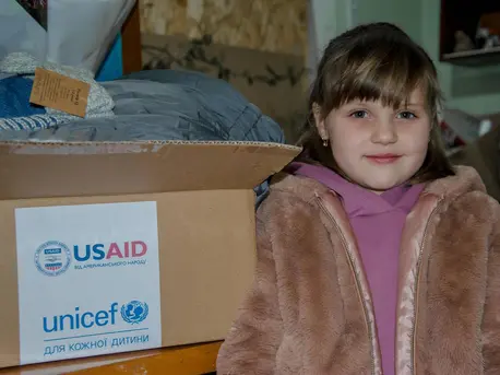 In Kotlyareve, Mykolaiv region, Ukraine, 5-year-old Ulyana and her brothers were thrilled to open a box from UNICEF containing warm winter clothes. In Kotlyareve, Mykolaiv region, Ukraine, 5-year-old Ulyana and her brothers were thrilled to open a box from UNICEF containing warm winter clothes.