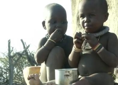 Two Young Children Eating