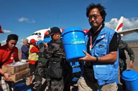 UNICEF Worker Holding Bucket