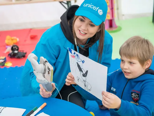 Yulia from UNCEF and Kostya, 7, are showing Kostya’s drawing of Wolverine during the live chat with Hugh Jackman who played Wolverine in X-men.