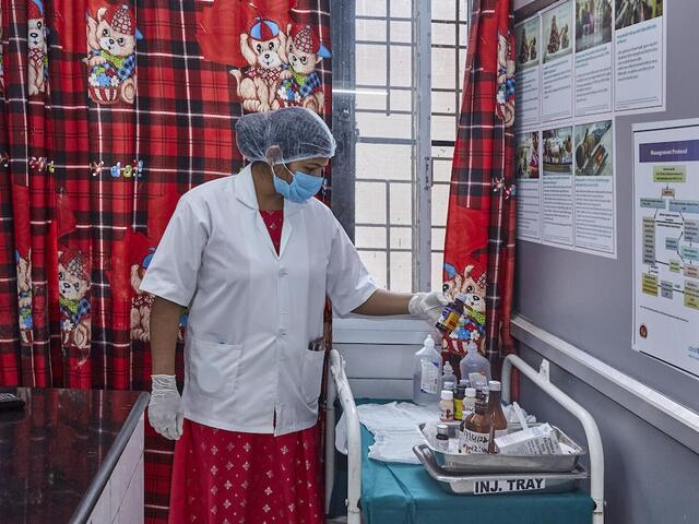 A health care worker follows compliance for labeling medicines at District Combined Hospital in Lodhi, Sonebhadra, Uttar Pradesh, India.