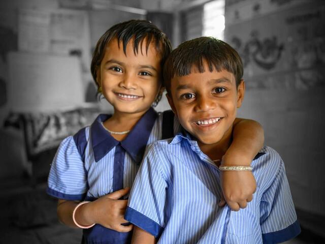 two friends in their UNICEF-supported classroom