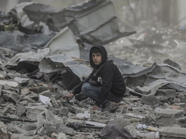 Ten-year-old Qusay searches in the wreckage of his home in in the Al-Touam area in the northern Gaza Strip.