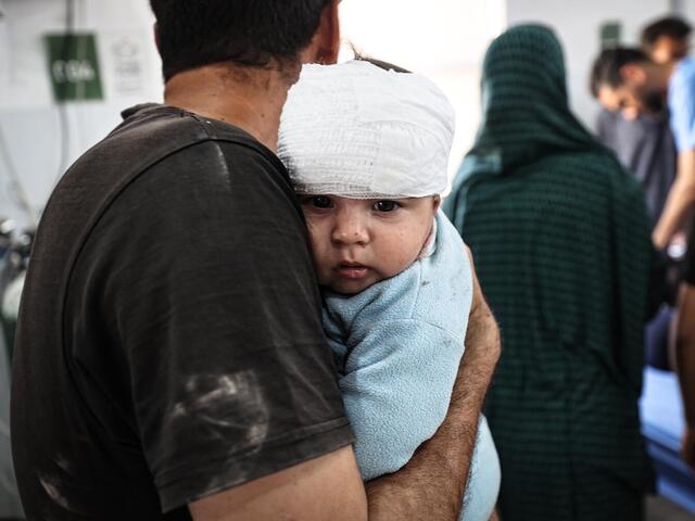 On May 22, 2025, Fares Nassar, 8 months old, receives treatment at Al-Awda Hospital in Nuseirat camp after an airstrike targeted the Al-Hasayneh School, housing displaced Palestinians.