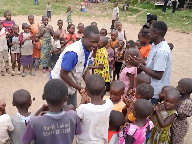 Bienfait, community social worker in North Kivu, DRC, with children he supports.