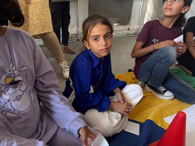 Ten-year-old Waed, center, participates in a UNICEF-supported Mental Health and Psychosocial Support (MHPSS) activity in Khan Younis, State of Palestine.