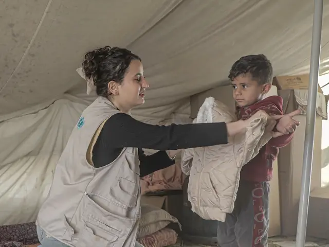 A young boy in Gaza receives a winter jacket during a UNICEF winter aid distribution.