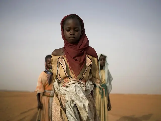 A UNICEF archival image of girls leaving a displacement camp to gather firewood in Darfur, Sudan, in 2005.