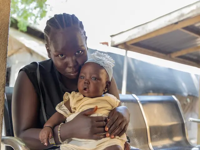 A mother brings her baby for routine vaccination at UNICEF-supported Munuki Health Center in Juba, Central Equatoria State, South Sudan.