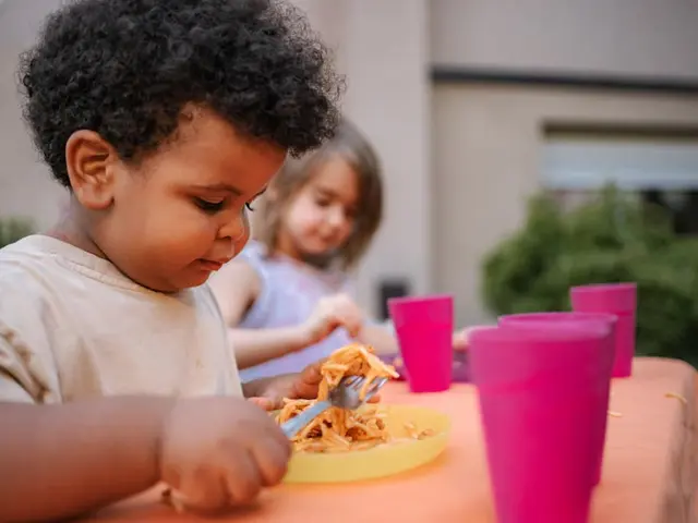 Young child eating outdoors