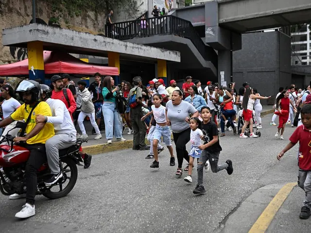 People run into a street following an earthquake in Caracas on June 24, 2026.