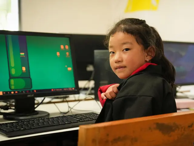 A 7-year-old girl in Bhutan learns coding in a computer lab through a UNICEF program