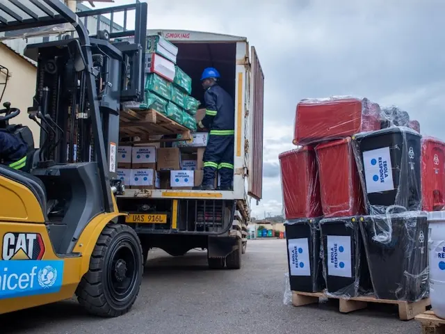 A man uses a forklift to load Ebola outbreak response supplies onto a truck.