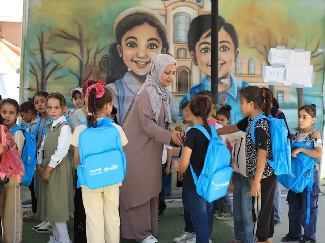 Children with UNICEF backpacks greet their new teacher on the first day of school in Gaza on Sept. 21, 2026.