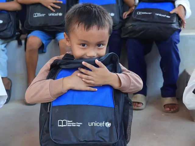 One month after devastating floods, a boy holds a new UNICEF backpack filled with school supplies in Nuwakot, Nepal.