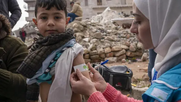 On Feb. 10, 2023, Hamzeh, 4, is screened for malnutrition by Hiba, a UNICEF-supported mobile health team leader,  in the Alsalheen neighborhood of the city of Aleppo, northern Syria. 