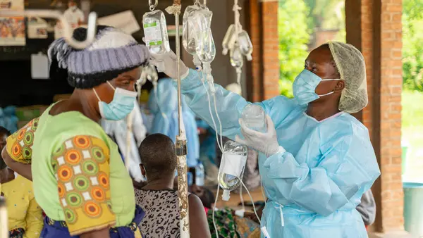 A UNICEF-supported health worker cares for multiple cholera patients at Area 18 Health Center in Lilongwe, Malawi.