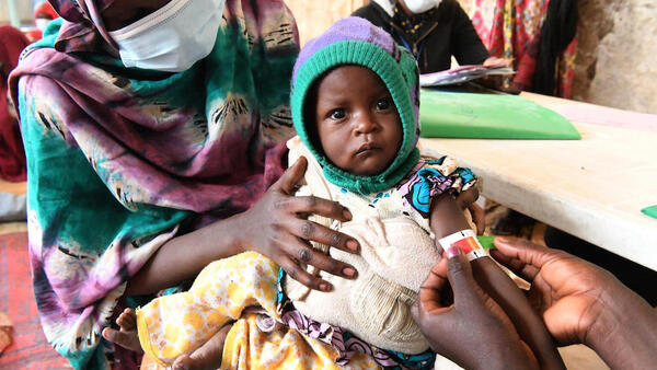 On Jan. 28, 2022, in Ndjamena, Chad, a child's upper arm circumference is measured by a health worker to screen for malnutrition at a UNICEF-supported outpatient nutrition unit.