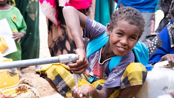 A child drinks from a tap at Barilays IDP site where UNICEF provides water to drought-affected communities, Somali region Ethiopia.