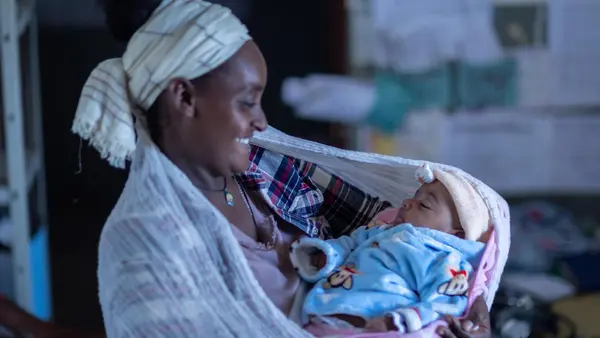 Kokobe Ashebir, 20, holds her 2-month-old baby during a routine checkup at a UNICEF-supported health clinic in Sire, Oromia region, Ethiopia.